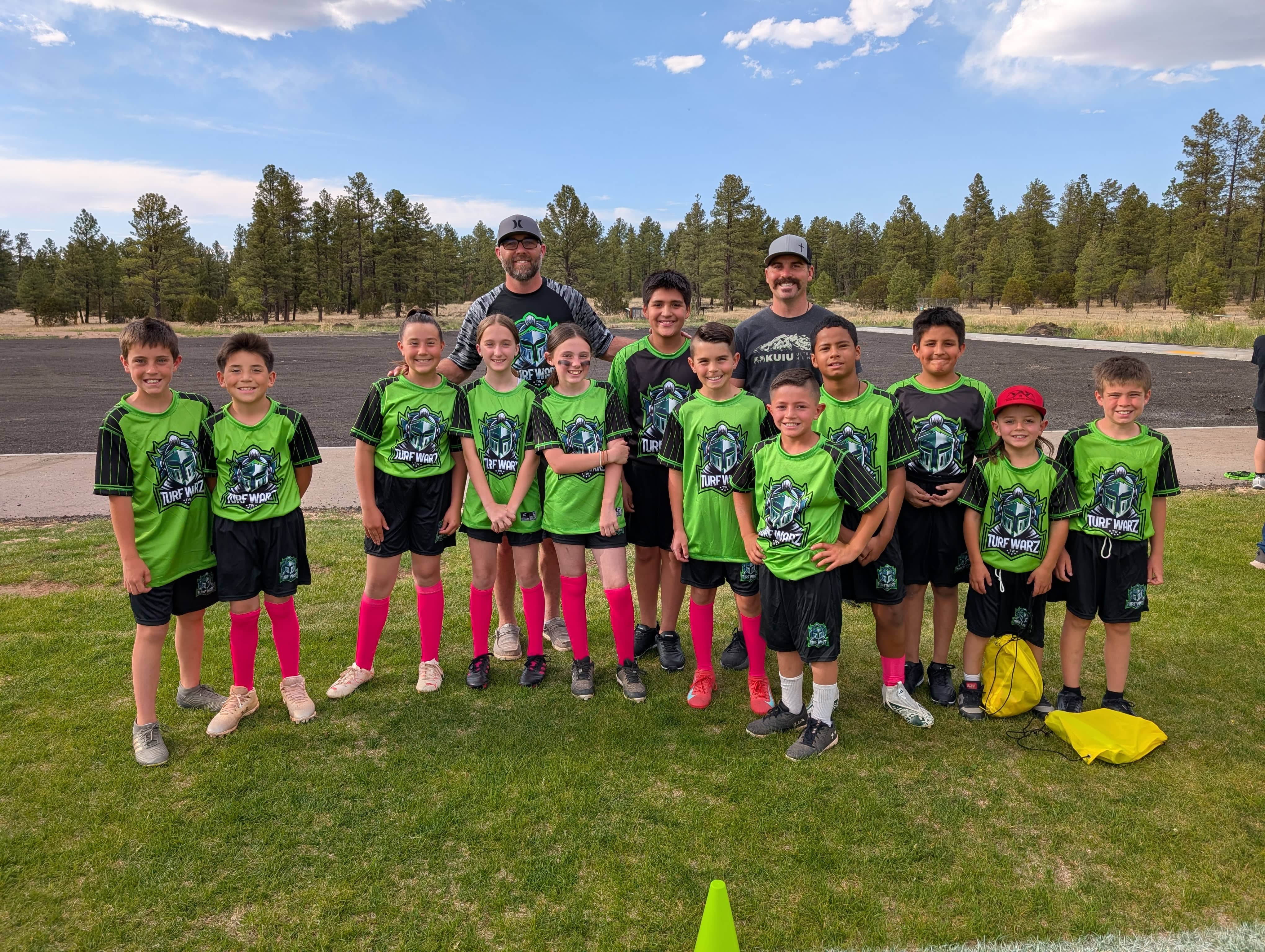 Youth football coach teaching players